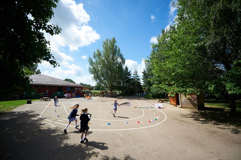 Playground with cones and four girls playing